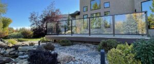 Modern vinyl deck with Duradek waterproof surface and custom aluminum glass railing in Edmonton