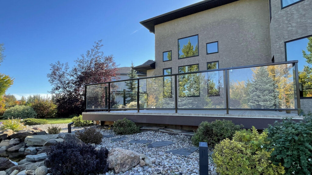 Completed deck featuring Duradek vinyl decking and custom aluminum railings with glass in Edmonton, Alberta.