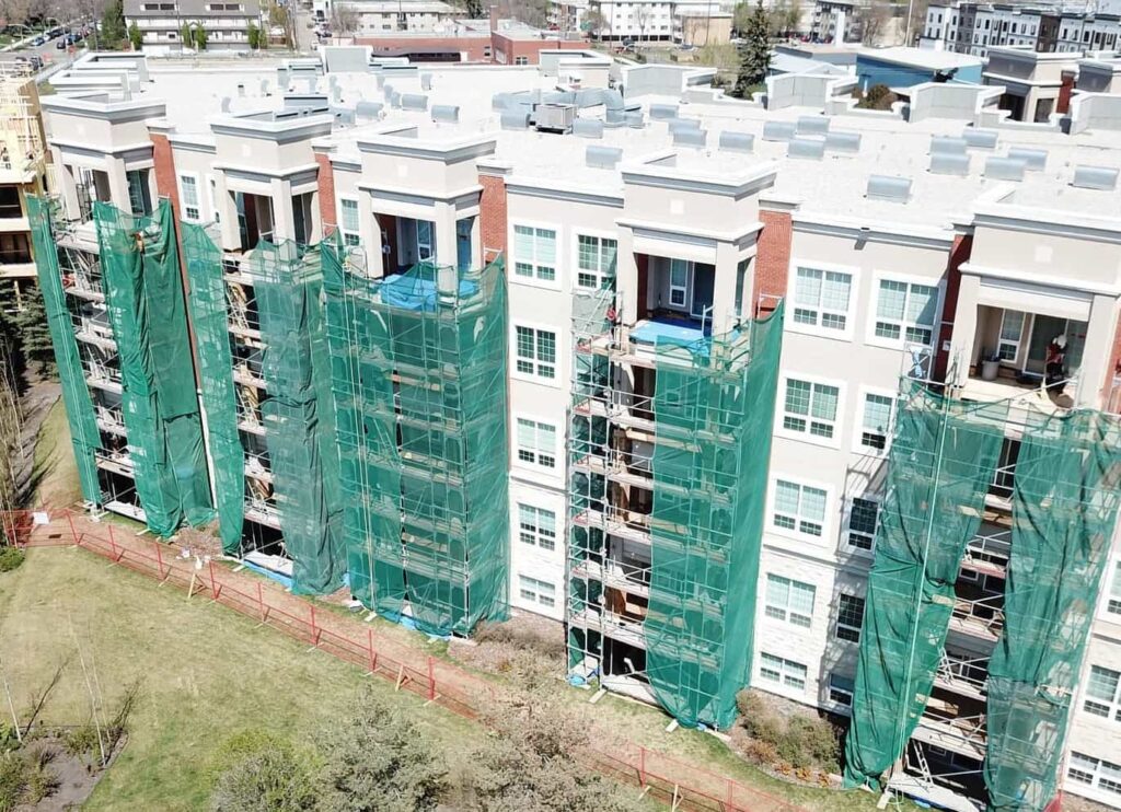 Large commercial building in Edmonton with newly installed decks and custom metal railings by CBS Alberta, expert general contractors.